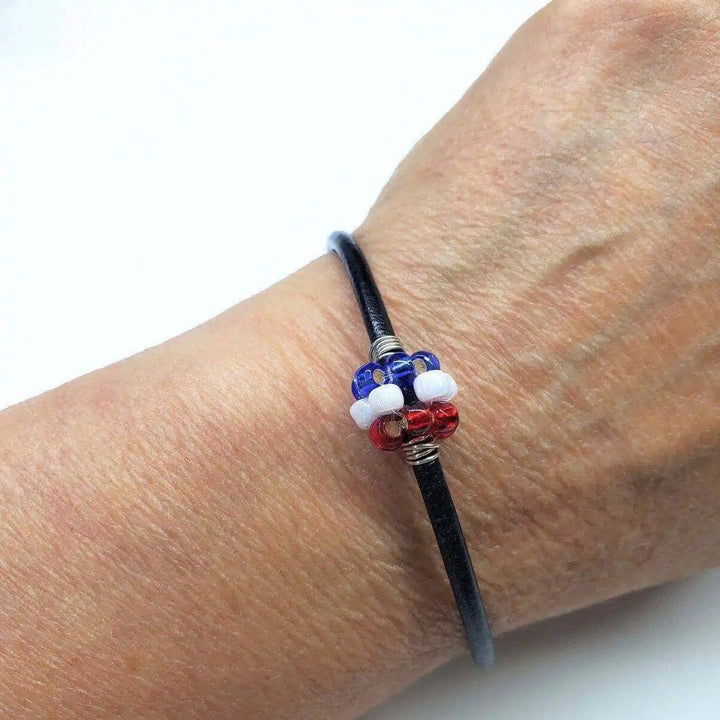 Patriotic Red White Blue Beaded Bead Leather Bracelet worn on a wrist showcasing its vibrant colors and handcrafted design.