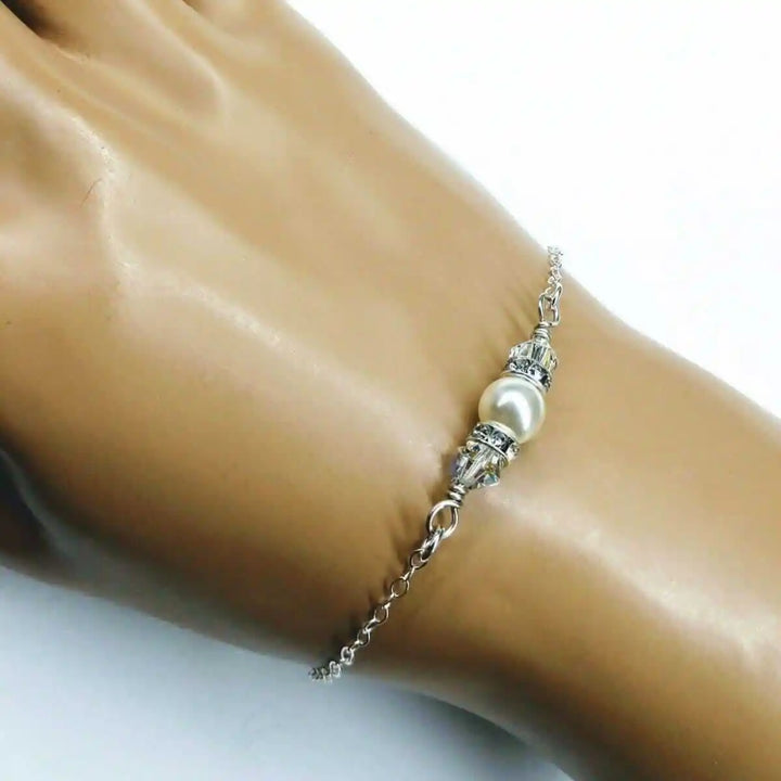 Silver Swarovski Crystal Pearl Bar Bridal Bracelet showcased on a hand, highlighting its elegant design and charm.