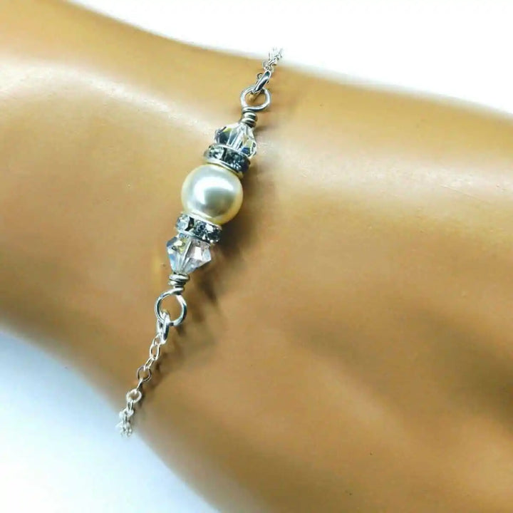 Silver Swarovski Crystal Pearl Bar Bridal Bracelet worn on a wrist, showcasing elegant design with pearls and crystals.