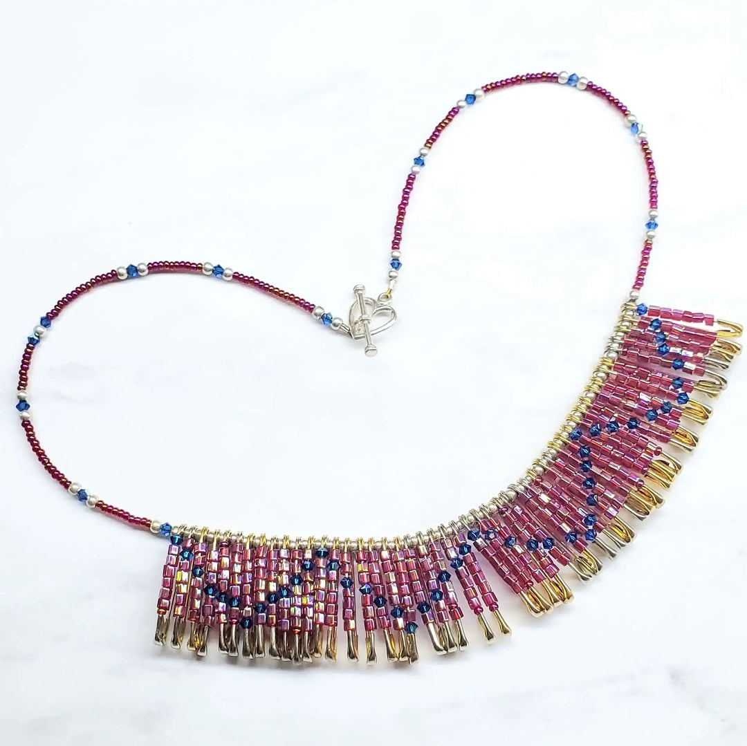 Handmade beaded Swarovski crystal zig zag bib choker necklace featuring colorful beads and golden brass safety pins.