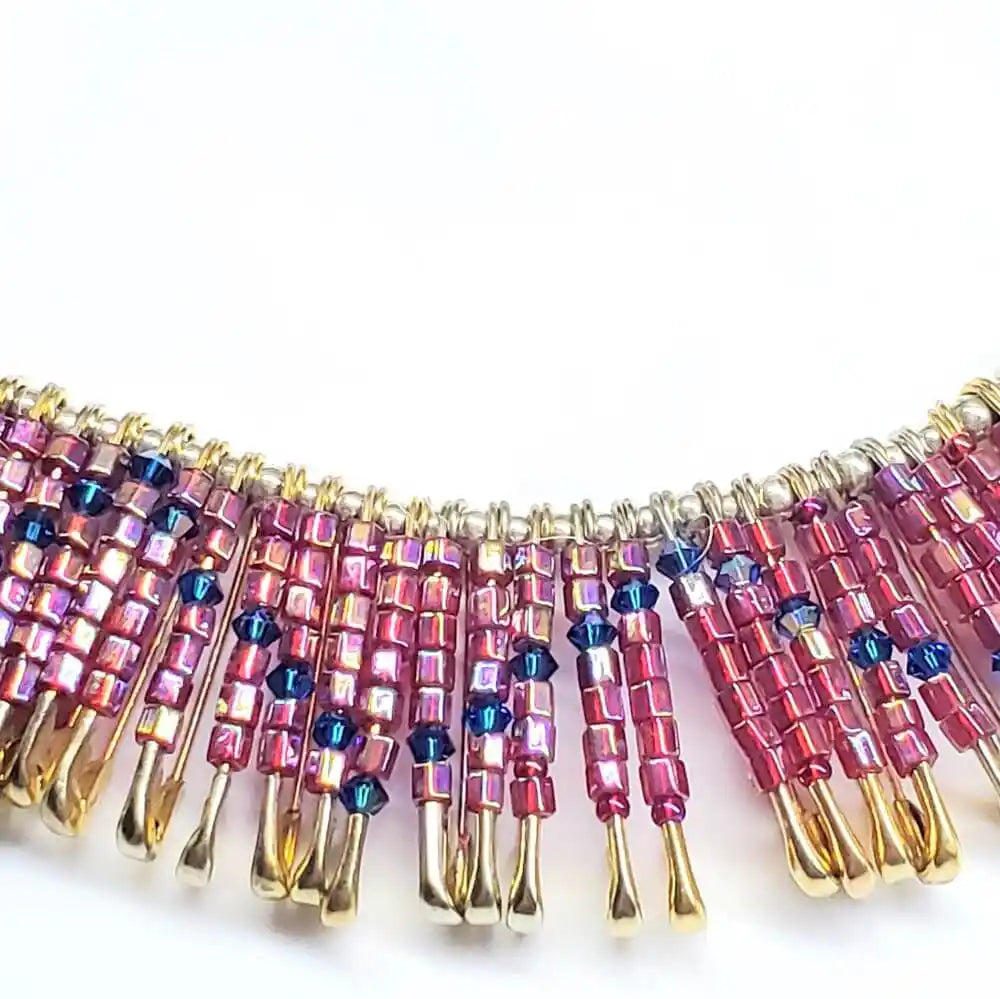 Handmade beaded Swarovski crystal zig zag bib choker necklace showcasing vibrant pink and gold colors.