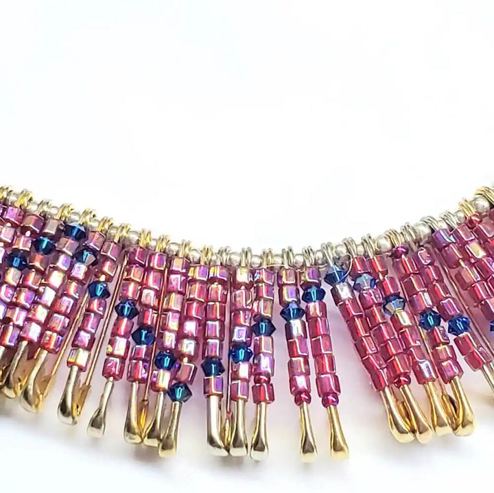 Handmade beaded Swarovski crystal zig zag bib choker necklace showcasing vibrant pink and gold colors.