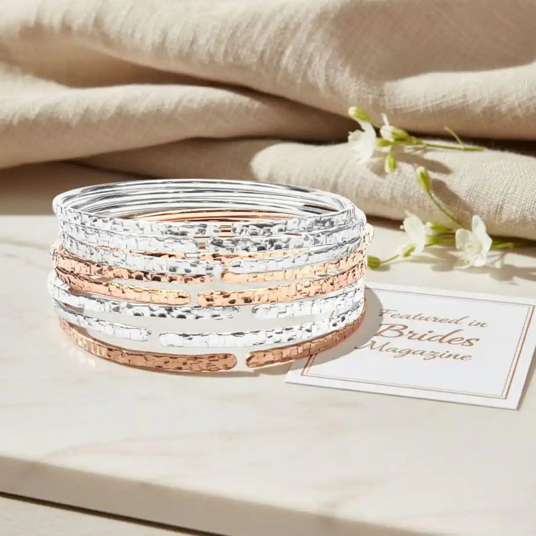 10 Gauge 925 Silver Hammer Textured Bangle stacked with rose gold bangles on a marble surface.