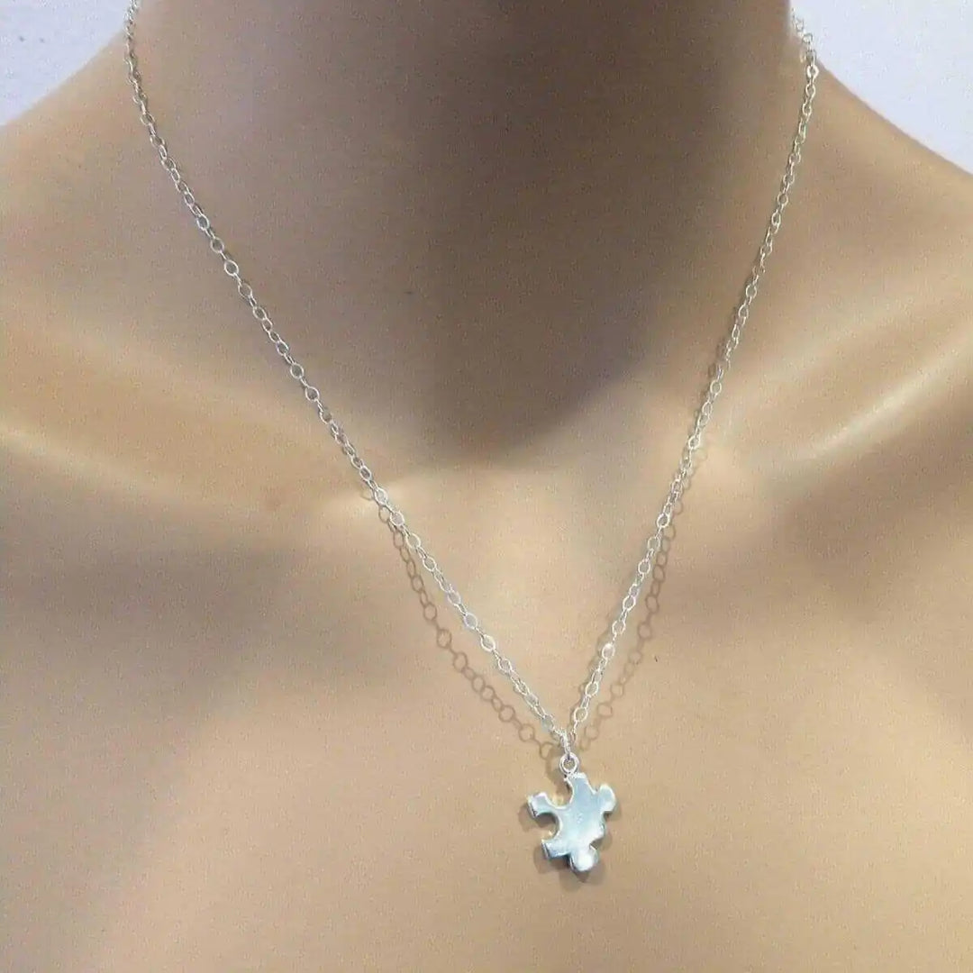 Sterling Silver Autism Awareness Puzzle Piece Chain Necklace displayed on a mannequin&