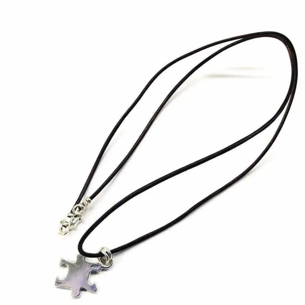 925 Silver Autism Awareness Puzzle Piece Leather Necklace on a black cord, featuring a silver puzzle piece pendant.
