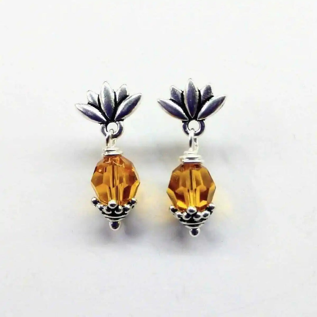 Silver Crystal Pineapple Steel Studded Earrings with topaz gemstone and floral accents.