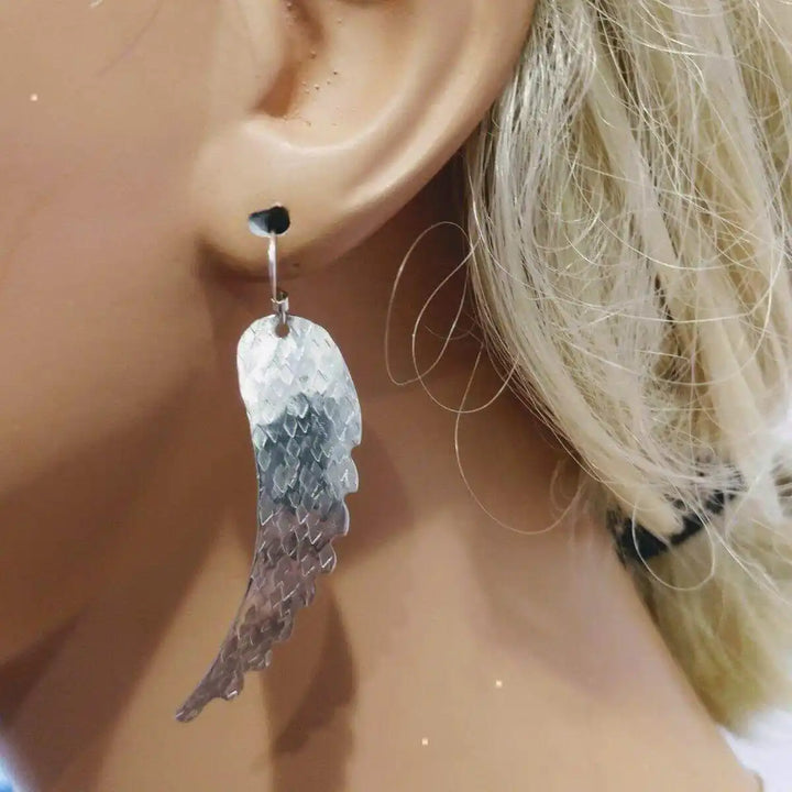 Silver Hammered Sculpted Angel Wing Earrings showcased on a mannequin&