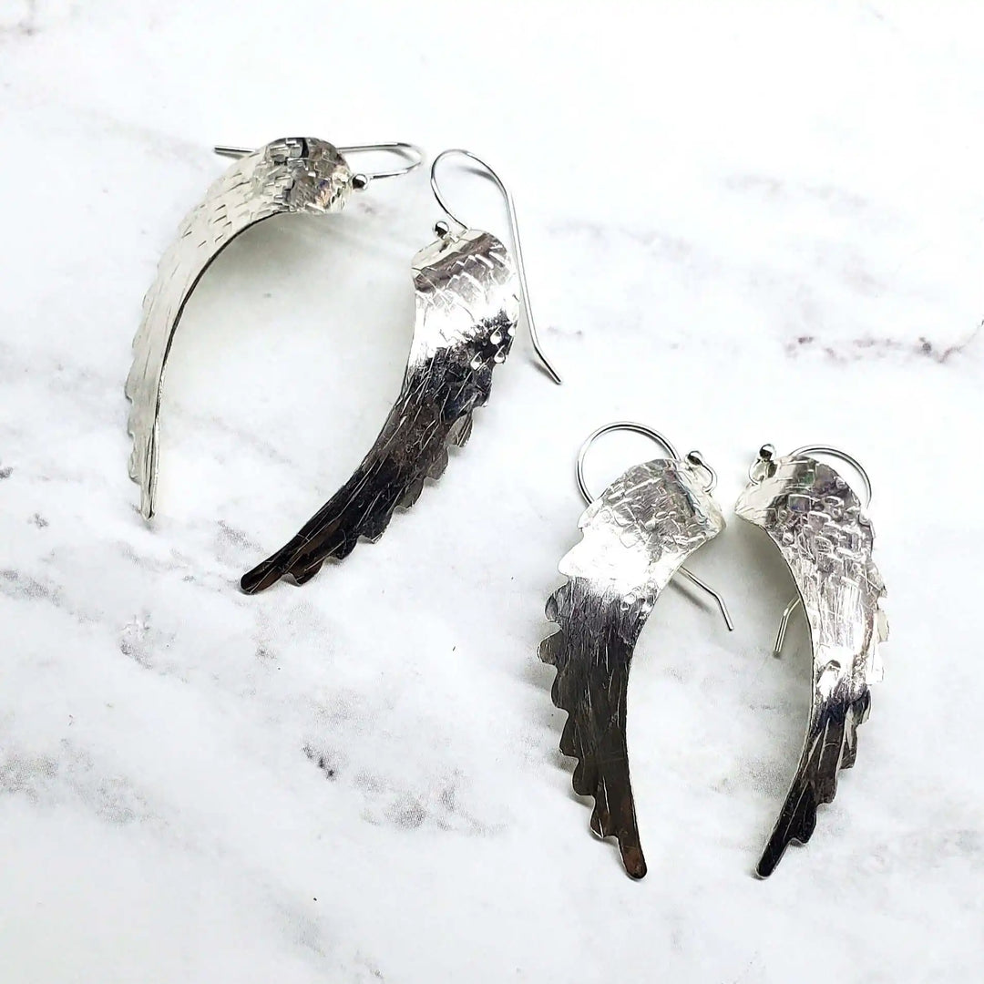 Silver Hammered Sculpted Angel Wing Earrings showcasing handcrafted design and intricate hammer-pattern texture.
