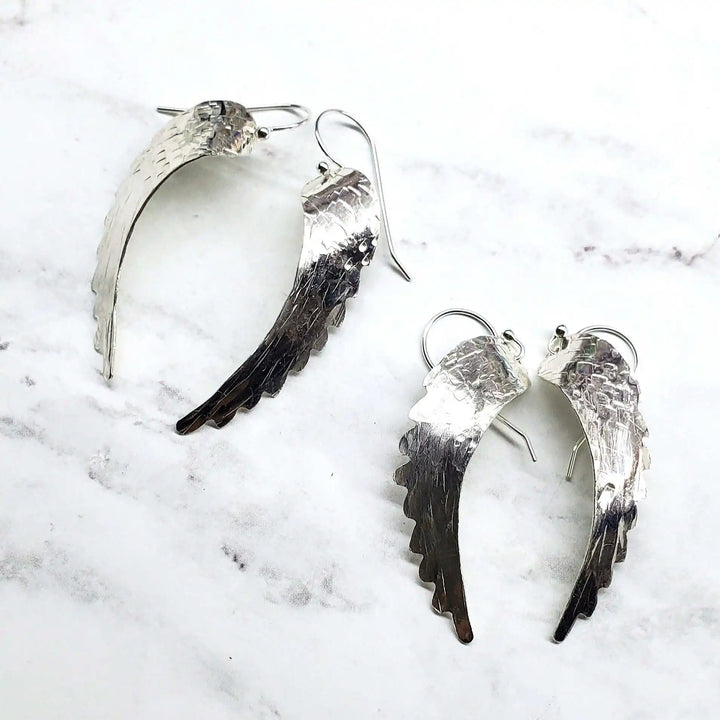 Silver Hammered Sculpted Angel Wing Earrings showcasing handcrafted design and intricate hammer-pattern texture.