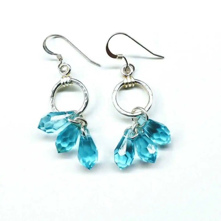 925 Silver Hammered Aqua Crystal Cascading Drop Earrings featuring hand-hammered silver and aqua Swarovski crystals.
