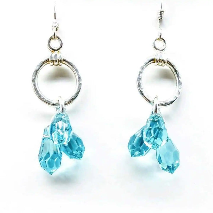 925 Silver Hammered Aqua Crystal Cascading Drop Earrings featuring hand-hammered circles and aqua Swarovski crystals.