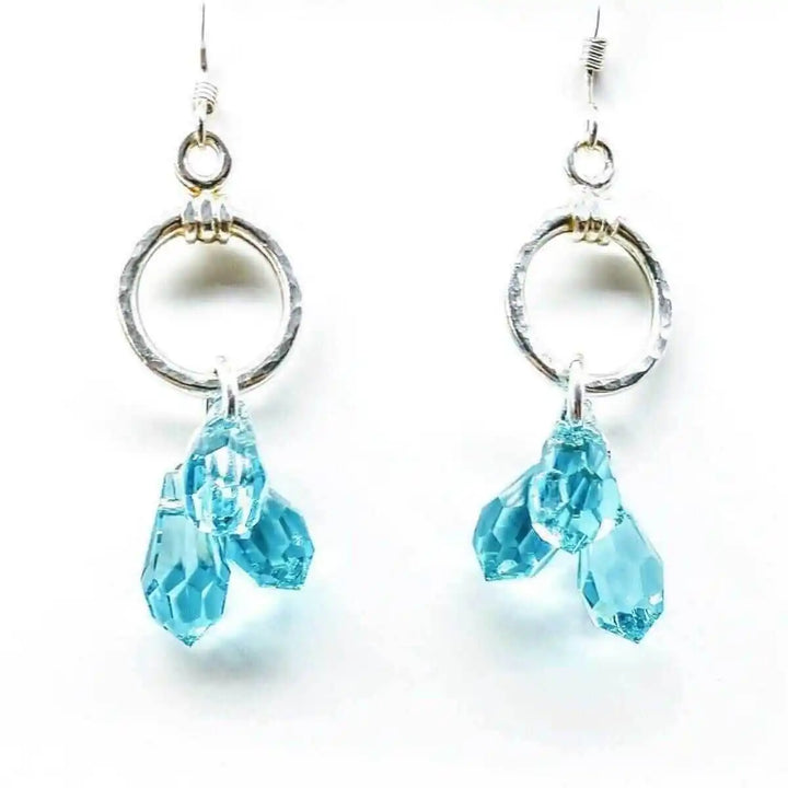 925 Silver Hammered Aqua Crystal Cascading Drop Earrings featuring aqua Swarovski crystals and hand-hammered silver.