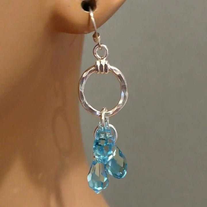 925 Silver Hammered Aqua Crystal Cascading Drop Earrings featuring sparkling aqua Swarovski crystals.