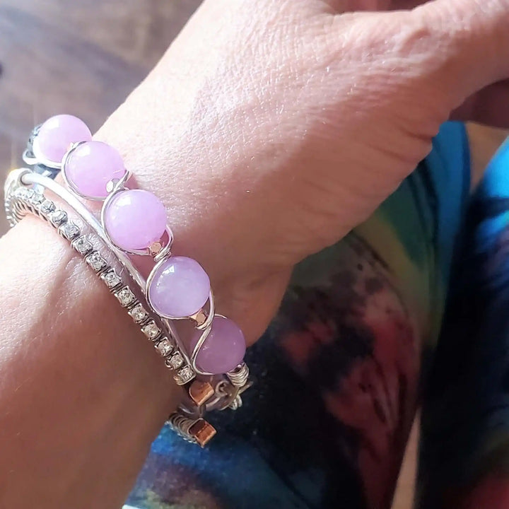 Silver Spiral Twist Wrap Purple Lava Rock Bangle Bracelet worn on wrist with purple lava rock accents and sparkling details.