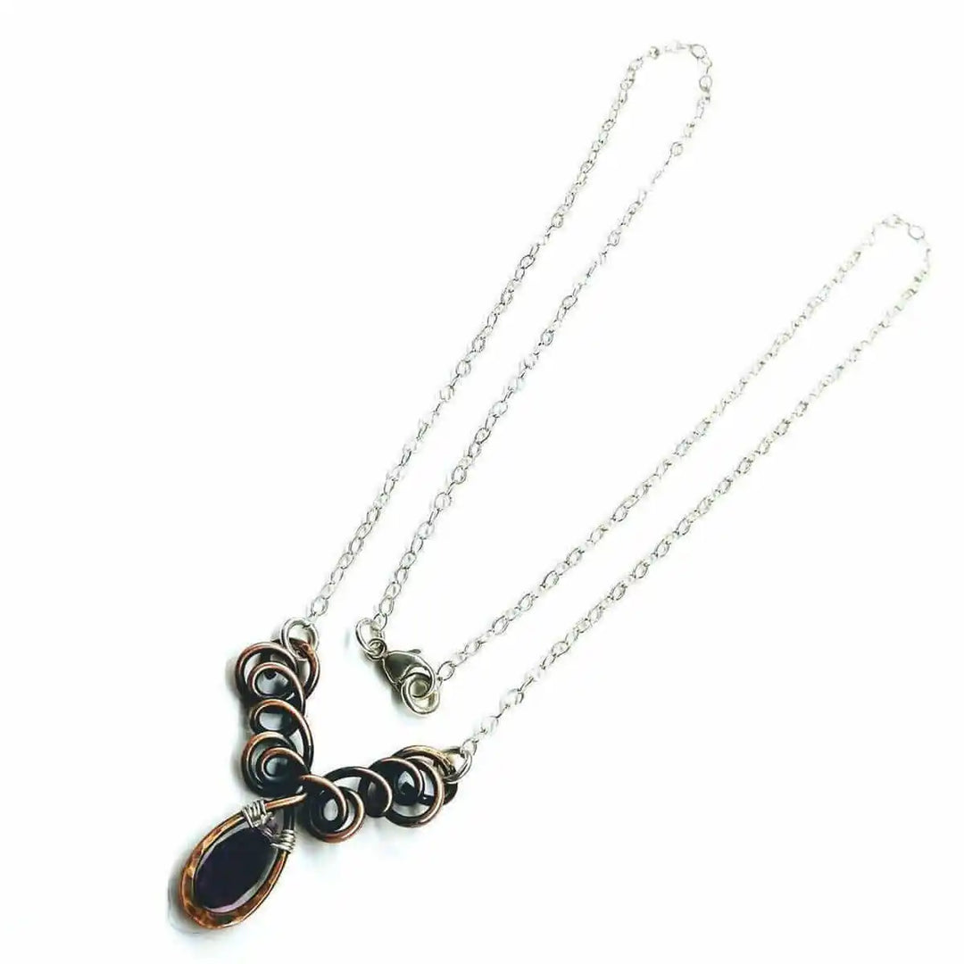 Silver and Copper Wire Sculpted Purple Crystal Drop Necklace featuring unique wire sculpture and an amethyst Swarovski drop.