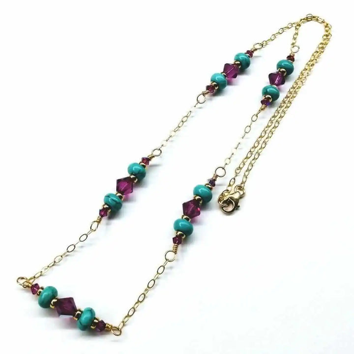 Wire Wrapped Gold Filled Pink Turquoise Gemstone Necklace with turquoise beads and fuchsia crystals on a gold chain.