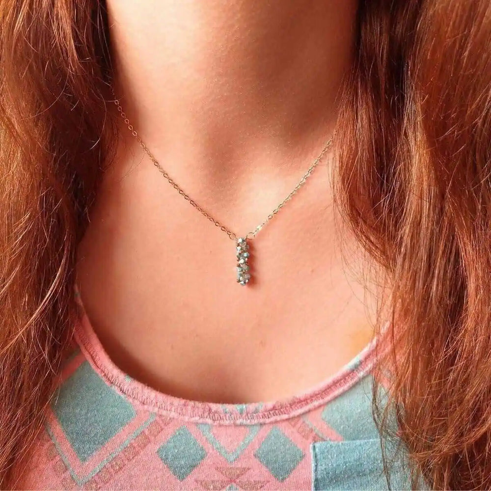 Tiny Super Sparkly Rock Candy Crystal Bar Necklace worn by a person with long hair, showcasing its delicate sparkle.