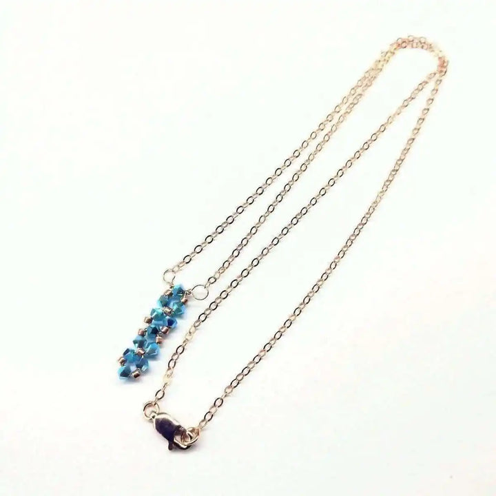 Tiny Super Sparkly Rock Candy Crystal Bar Necklace with Turquoise ABx2 Swarovski crystals on a delicate chain.