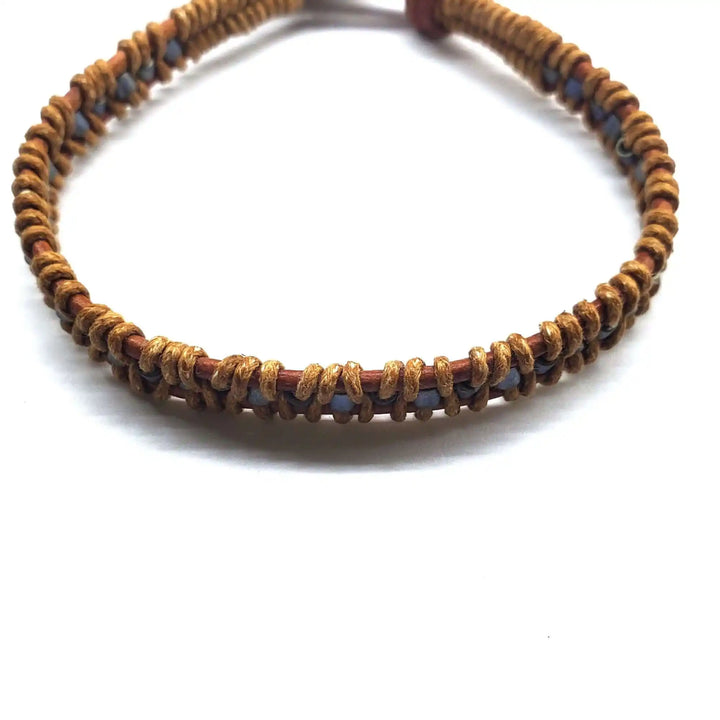 Handmade Tree of Life leather wrap bracelet featuring earthy brown and gray seed beads, handcrafted in Montana.