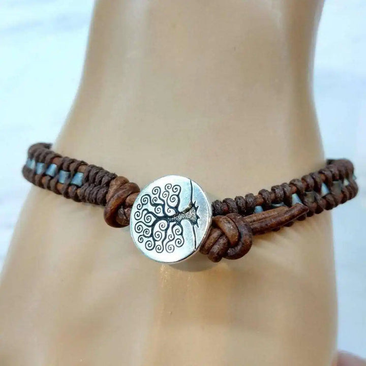 Handmade Tree of Life leather wrap bracelet featuring brown gray seed beads and a decorative silver clasp.