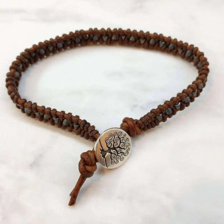 Handmade Tree of Life leather wrap bracelet featuring brown gray leather wrap and a tree of life charm.
