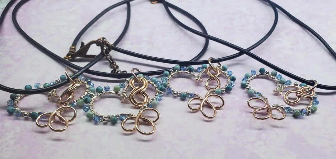 Wire Wrapped Copper Turquoise Heart Infinity Charm Necklace featuring turquoise beads and infinity charm on black cord.