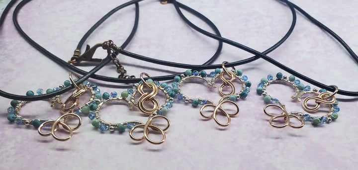 Wire Wrapped Copper Turquoise Heart Infinity Charm Necklace featuring turquoise beads and infinity charm on black cord.