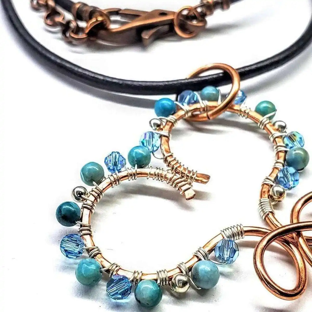 Wire Wrapped Copper Turquoise Heart Infinity Charm Necklace featuring turquoise and Swarovski crystals, showcasing artisan craftsmanship.