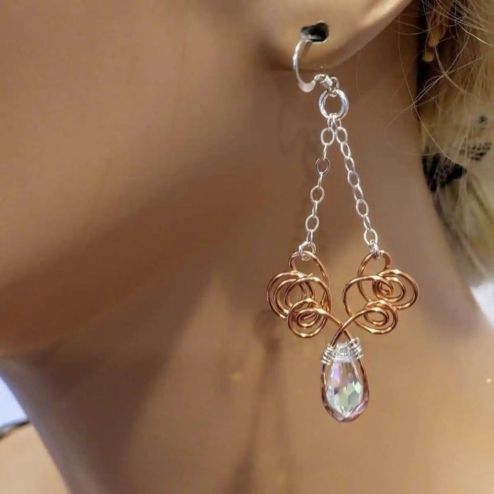 Wire Sculpted Crystal Drop Chandelier Angel Wing Earrings showcased on a mannequin ear, highlighting their unique design.