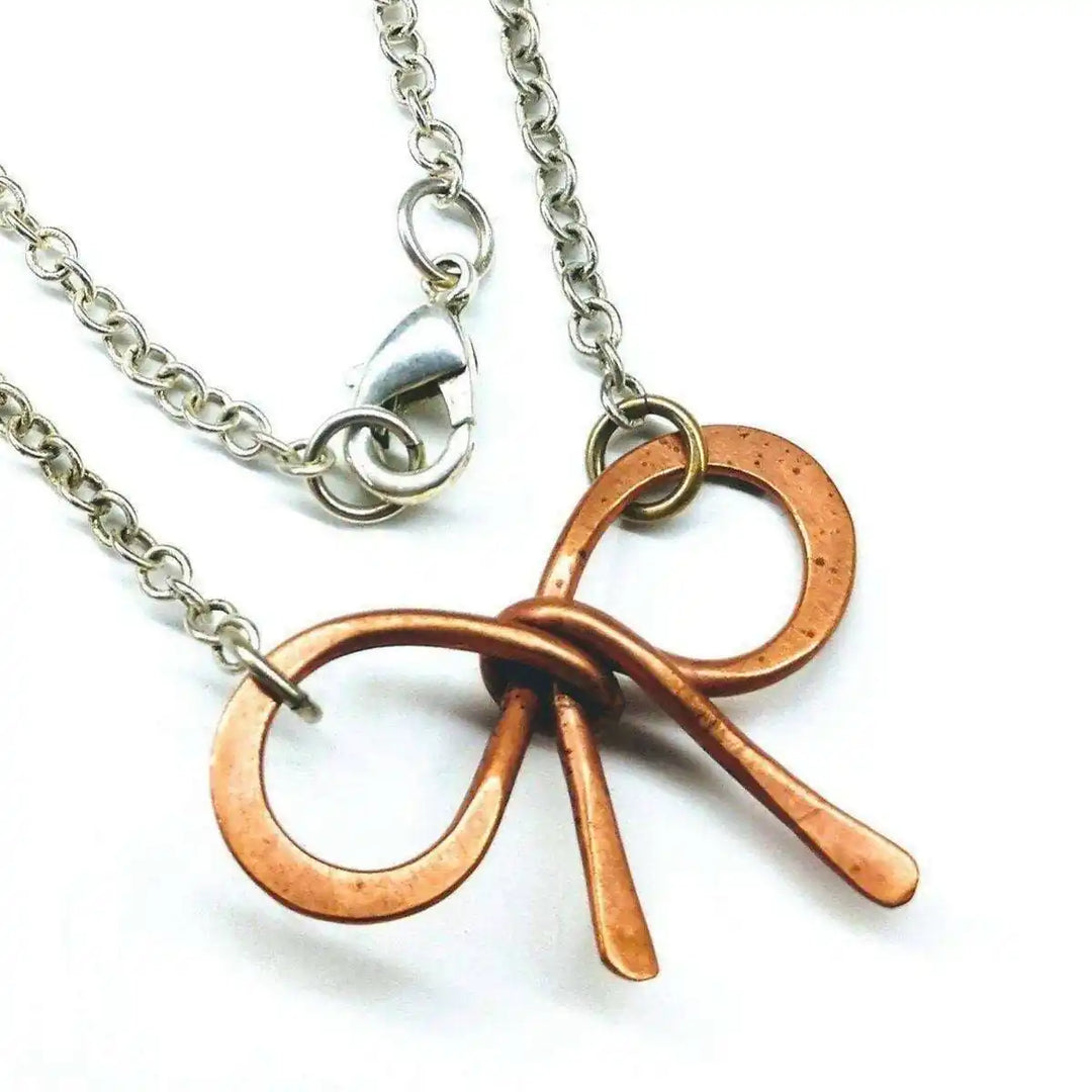 Wire Wrapped Copper Bow Tie Silver Chain Necklace featuring a hand-sculpted copper pendant on a silver chain.