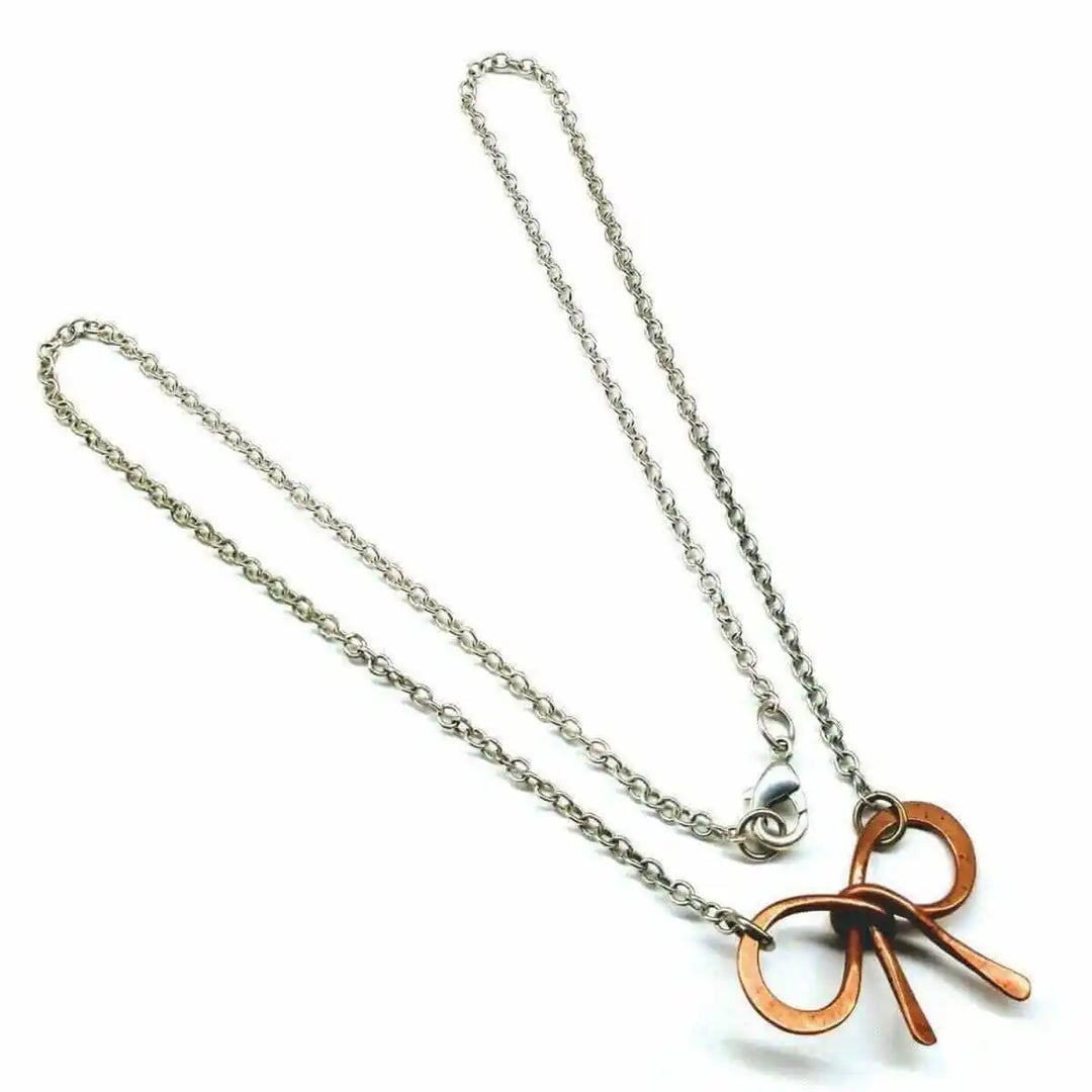 Wire Wrapped Copper Bow Tie Silver Chain Necklace displayed on a white background with a close-up of the unique design.