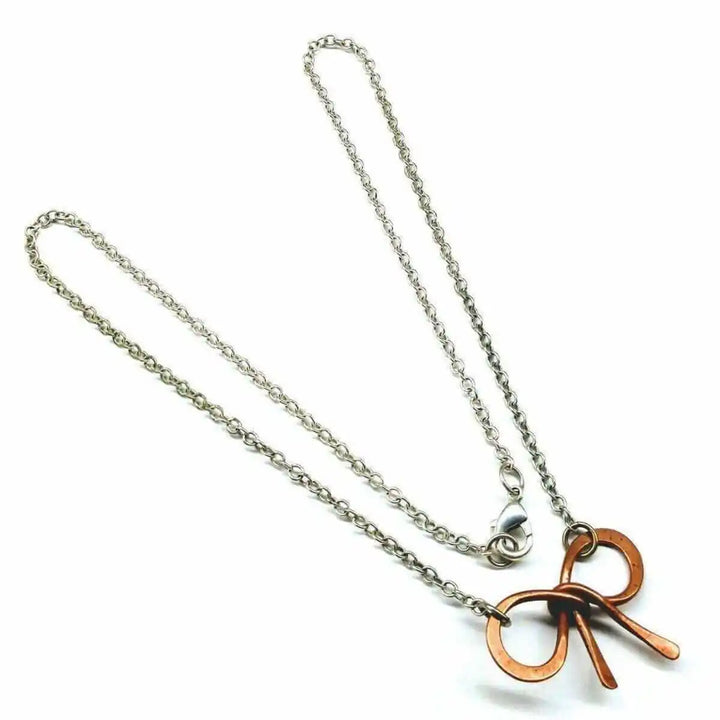 Wire Wrapped Copper Bow Tie Silver Chain Necklace displayed on a white background with a close-up of the unique design.