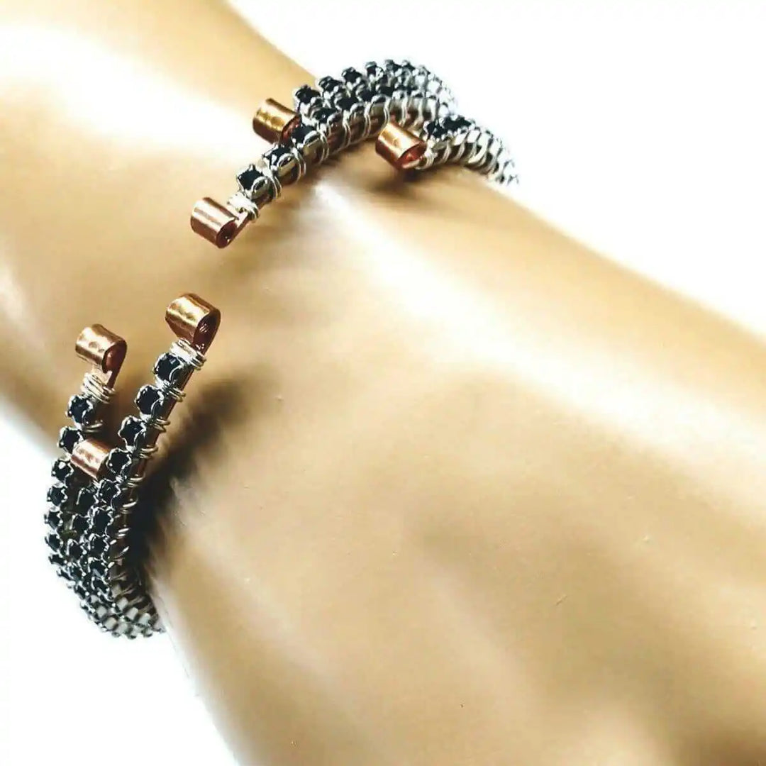 Wire Wrapped Copper Silver Black Crystal Rhinestone Bangle resting on a model&