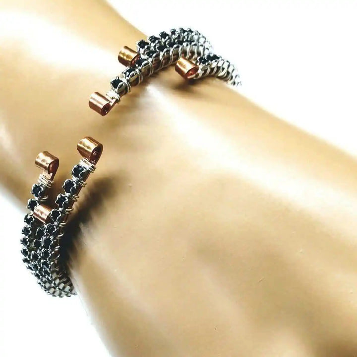 Wire Wrapped Copper Silver Black Crystal Rhinestone Bangle resting on a model&