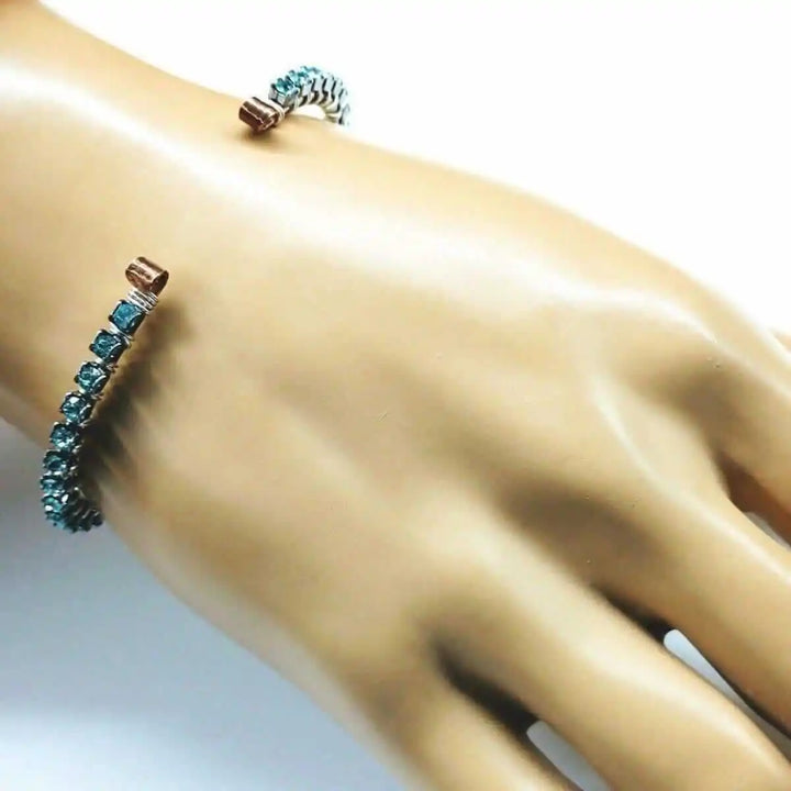 Wire Wrapped Turquoise Crystal Tennis Bangle Bracelet displayed on a hand showcasing the aqua blue Swarovski-quality crystals.