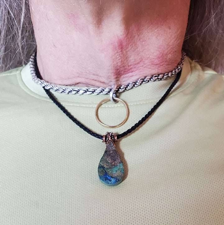 Older man wearing the Wire_Wrapped_Natural_Cut_Azurite_Malachite_Drop_Necklace front view
