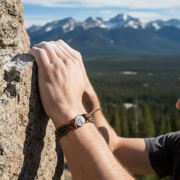 Hand wearing X-Large Leather Intricate Beaded Tree Of Life Bracelet against a mountain backdrop.