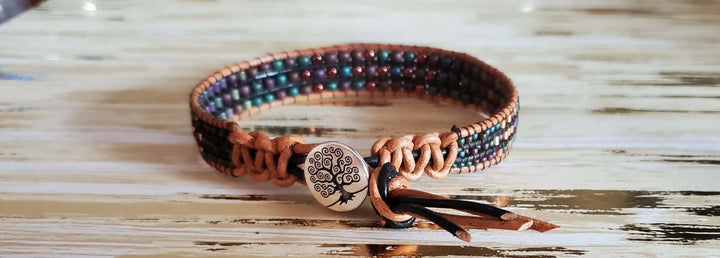 X-Large Leather Intricate Beaded Tree Of Life Bracelet on wooden surface with unique beadwork and leather design.