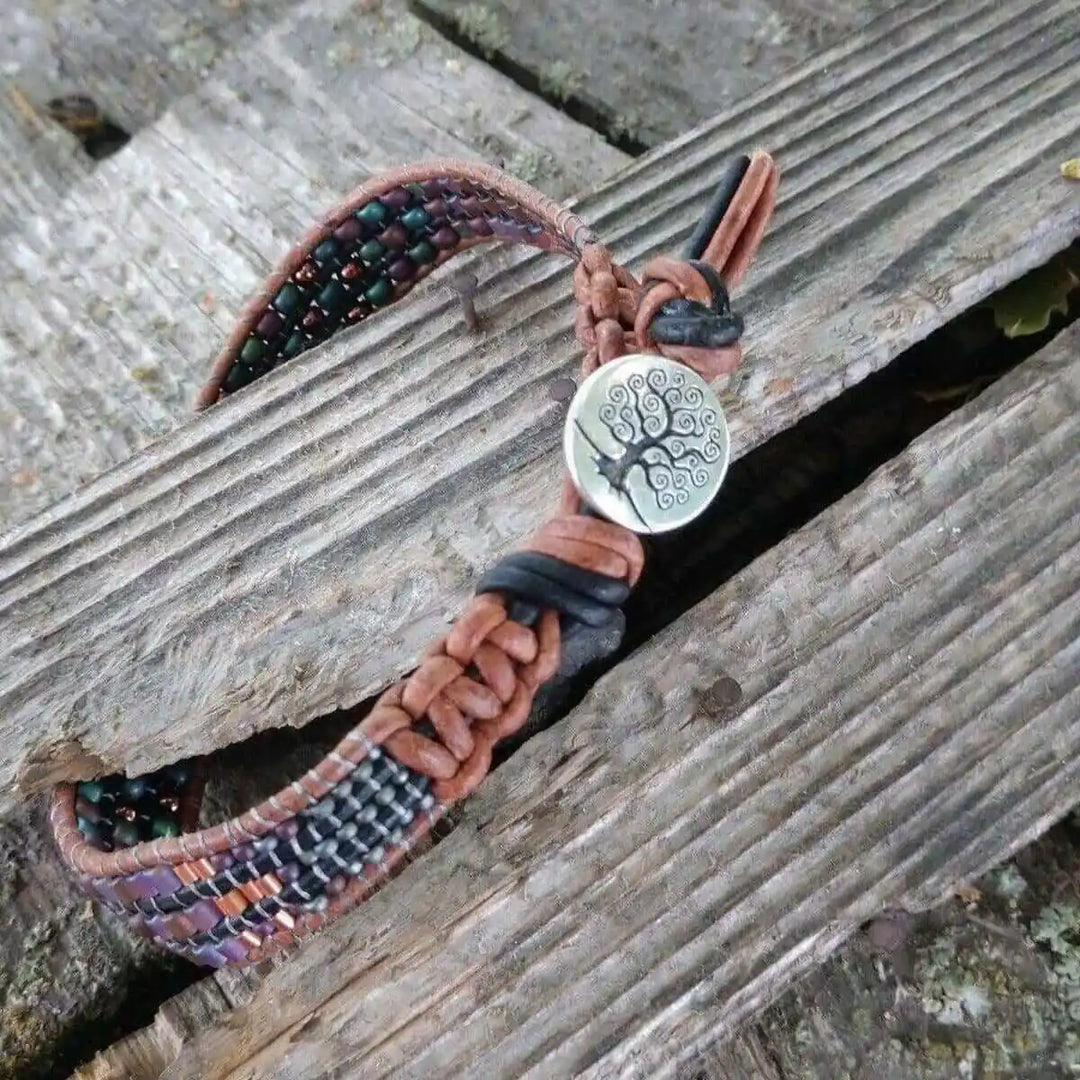 X-Large Leather Intricate Beaded Tree Of Life Bracelet featuring handcrafted beadwork and leather on a wooden surface.
