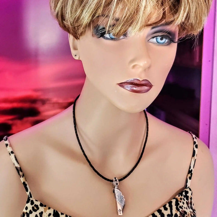 Sculpted Copper Angelwing Crystal Birthstone Necklace displayed on a mannequin with a stylish short haircut.