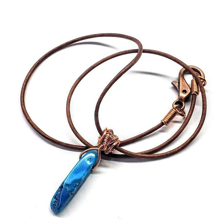Wire Wrapped Pointed Turquoise Agate Leather Necklace showcasing a turquoise-blue crystal on a leather cord.