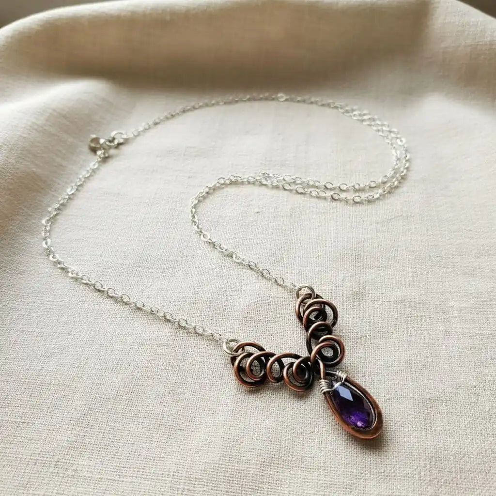 Silver and Copper Wire Sculpted Purple Crystal Drop Necklace showcasing unique wire design and amethyst Swarovski crystal.