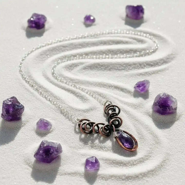Silver and Copper Wire Sculpted Purple Crystal Drop Necklace displayed with amethyst crystals on a white background.