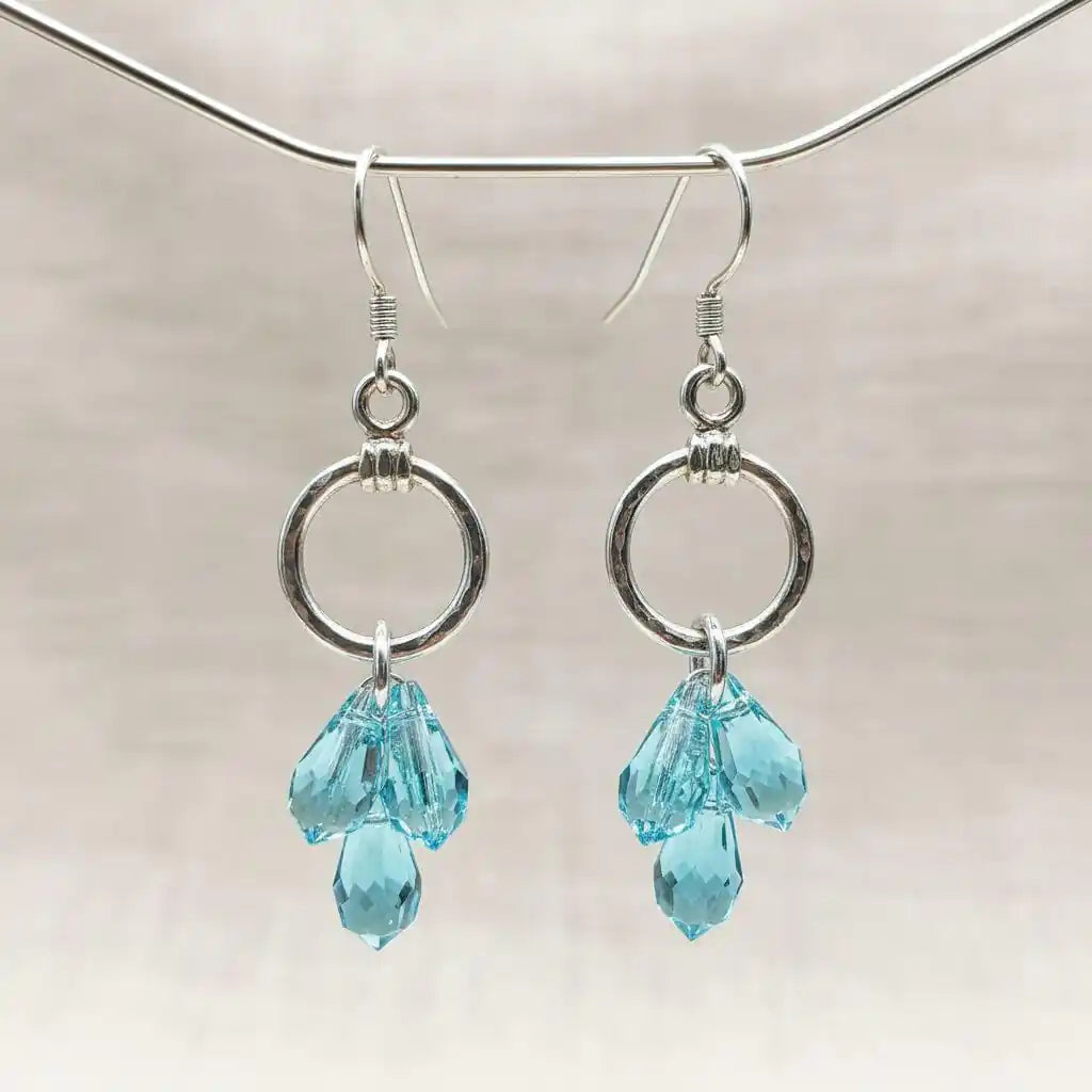 925 Silver Hammered Aqua Crystal Cascading Drop Earrings showcasing aqua Swarovski crystals in a stunning design.