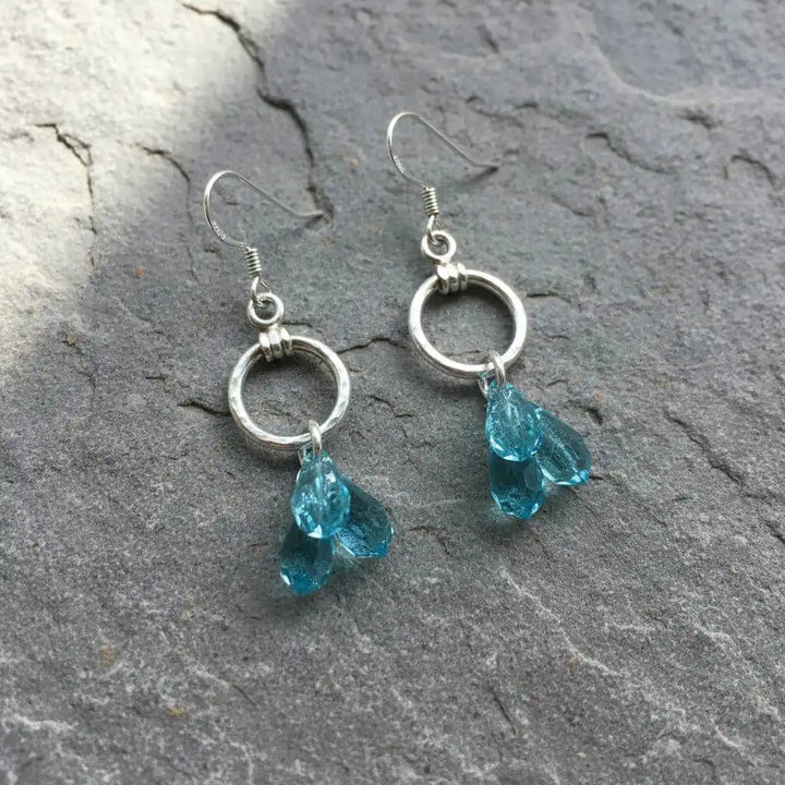 925 Silver Hammered Aqua Crystal Cascading Drop Earrings featuring aqua Swarovski crystals and hand-hammered silver components.
