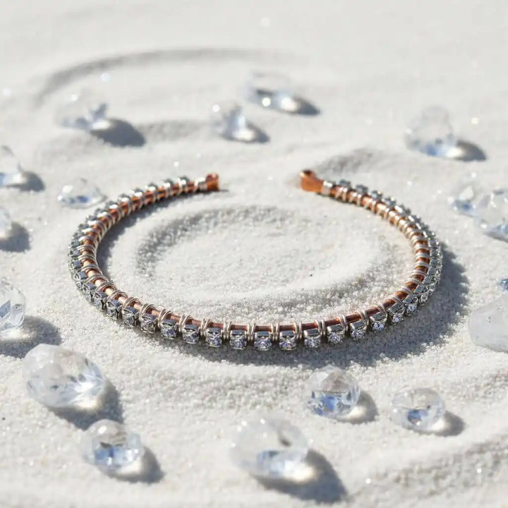 Catch-Free Crystal Rhinestone Tennis Bracelet Bangle on sand surrounded by sparkling crystals.