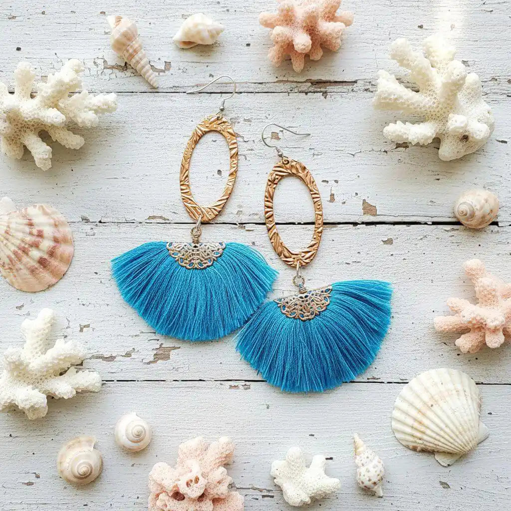 Long Copper Embossed Aqua Brushed Silk Fan Tassel Earrings with aqua tassels and golden metal accents