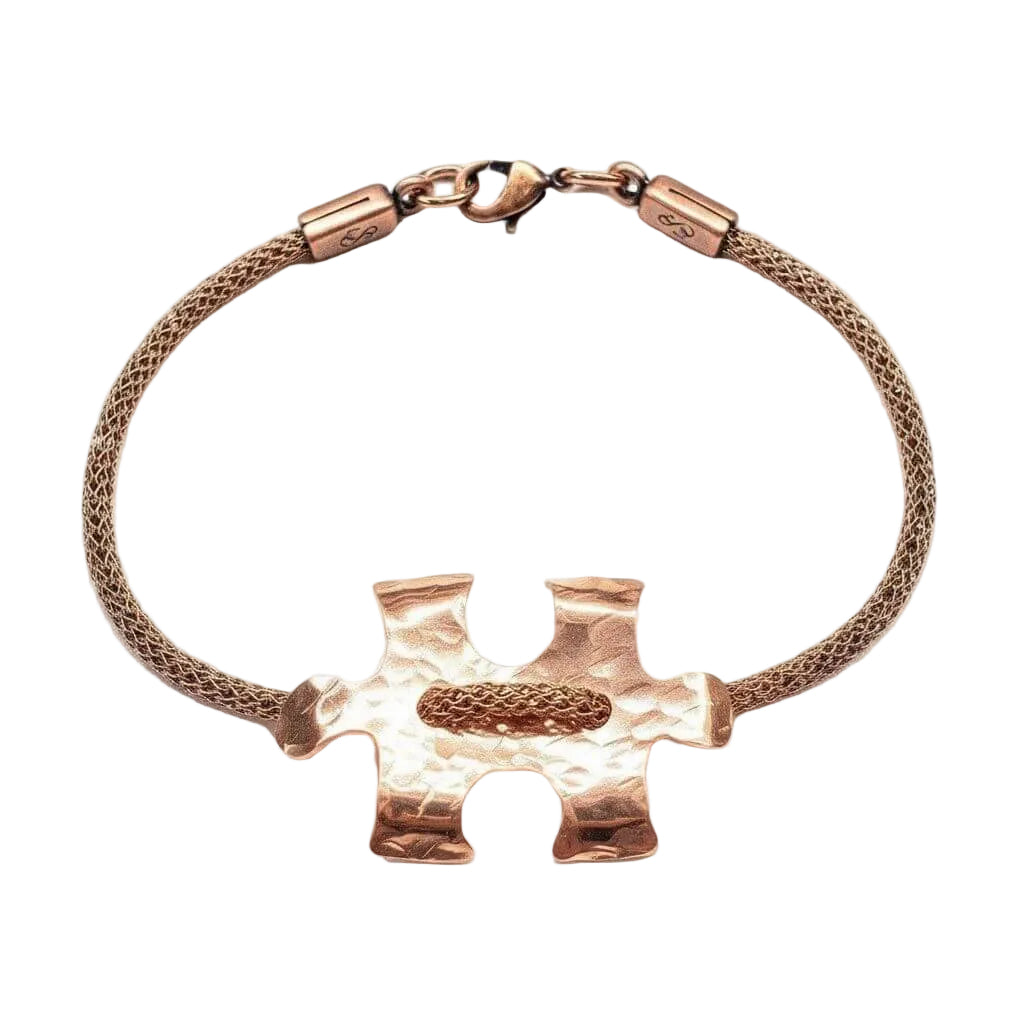 Rose gold puzzle piece bracelet on a white background