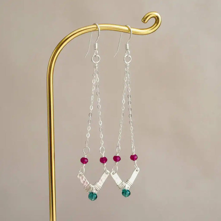 Sterling Silver Chevron Hot Pink Green Gemstone Earrings hanging on a jewelry stand with vibrant gemstones.
