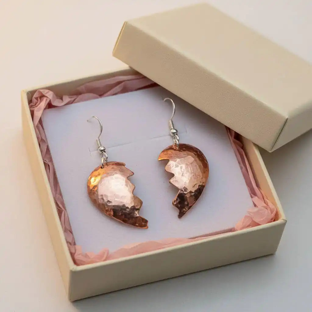 Handmade Sculpted Copper Broken Heart Earrings in a gift box with pink tissue paper.